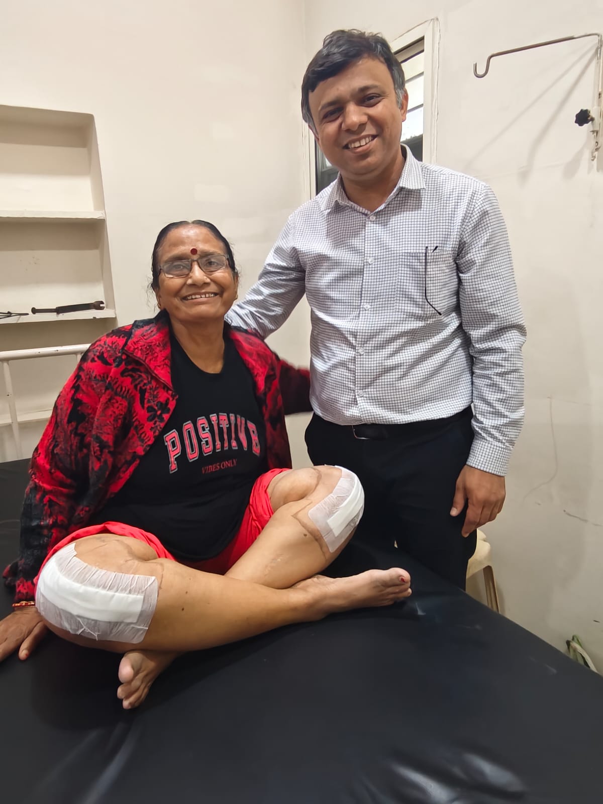 Dr Harsh Raval standing beside a woman at the clinic