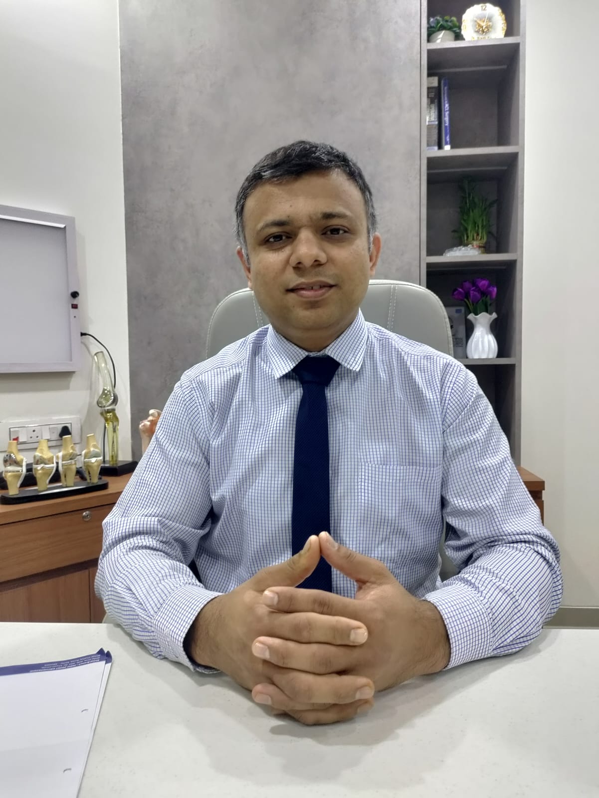 Dr Harsh Raval seated at his clinic desk